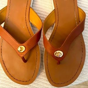 Coach brown leather with gold hardware flip flop.